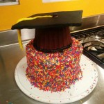 Picture of sprinkle cake with black mortarboard cake on top