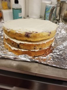 Stacked layer cake with buttercream crumb coating