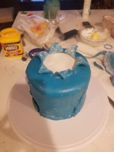 Blue fondant covered cake with the cuts coming out