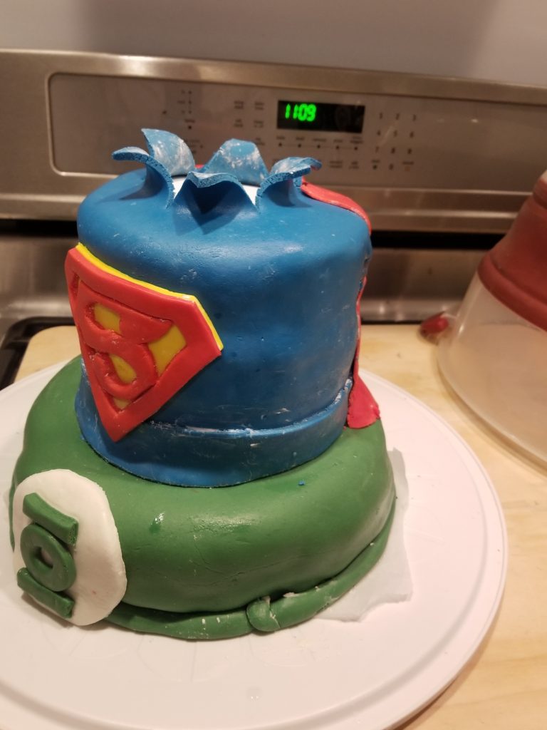 Green lantern cake on bottom, superman cake on top