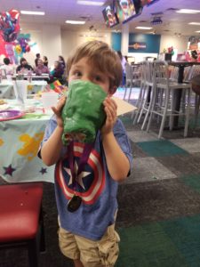 Kid eating a giant hulk fist made of rice krispies